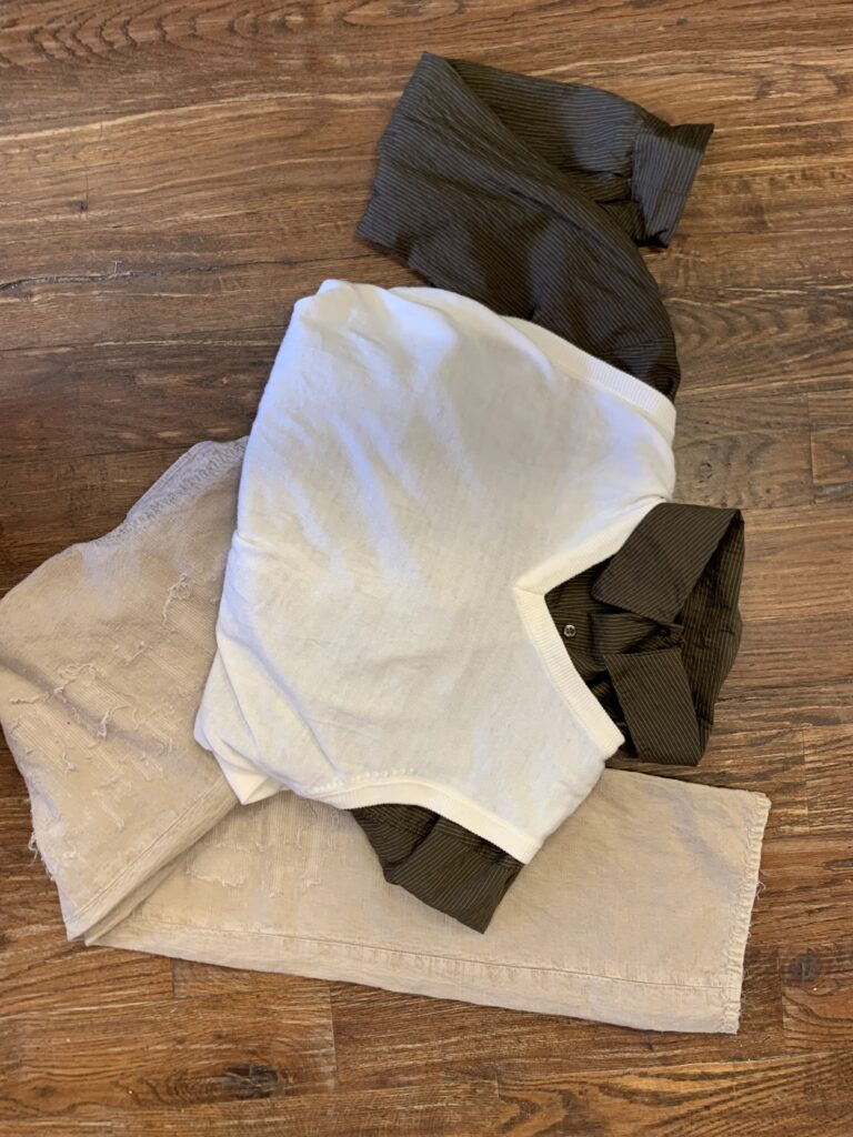 a pair of pants, shirt, and sweater vest that represent spring trends in men's fashion