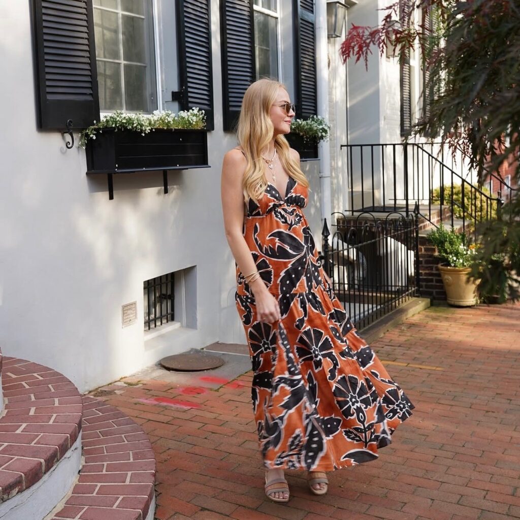 woman in long orange and navy flowy dress
