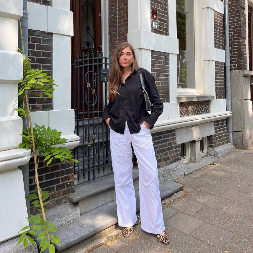 woman wearing linen pants with a black button-down