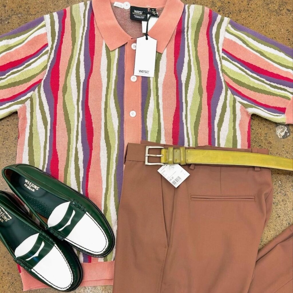 flatlay of cardigan, trousers with belt, and loafers
