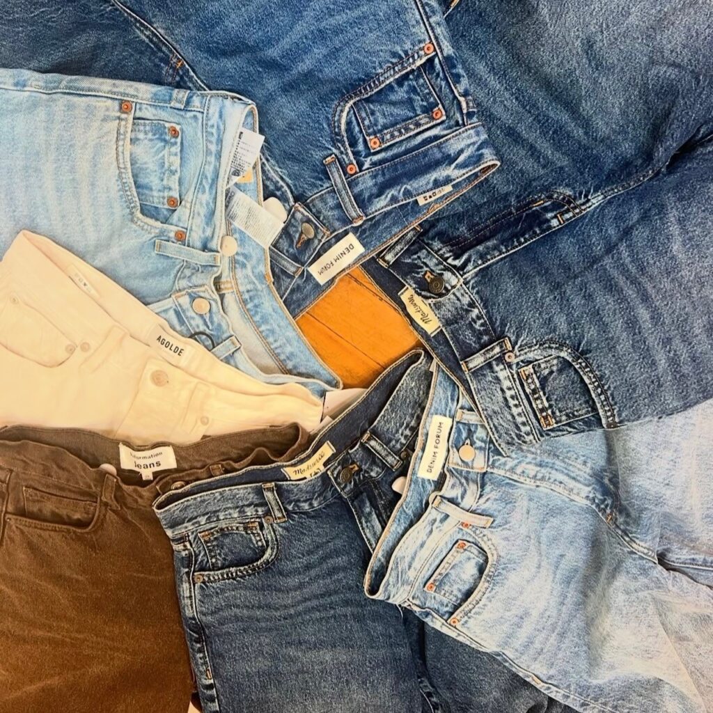 flatlay of multiple pairs of jeans