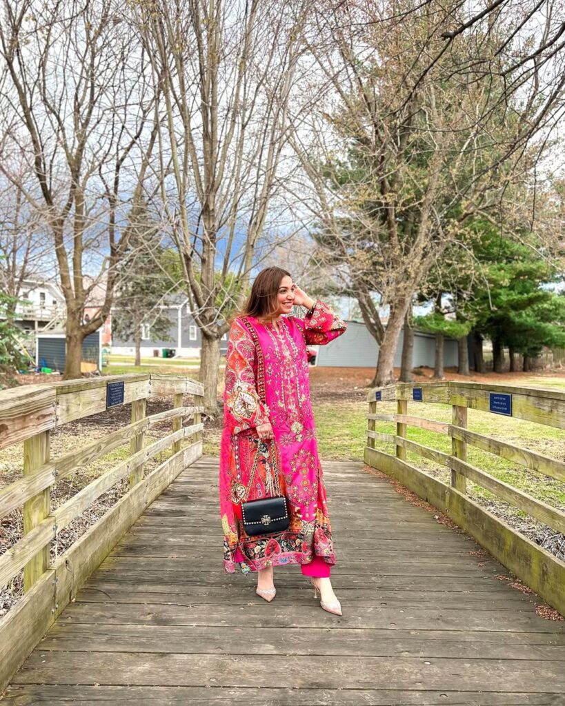 woman in bold pink floral tunic