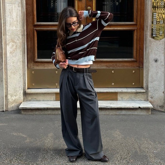 woman in trousers and striped rugby shirt