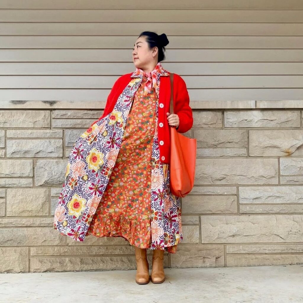 woman in layered dresses and red cardigan