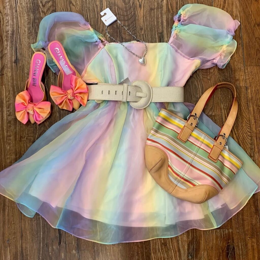 A pastel-colored dress with bow heels and striped handbag