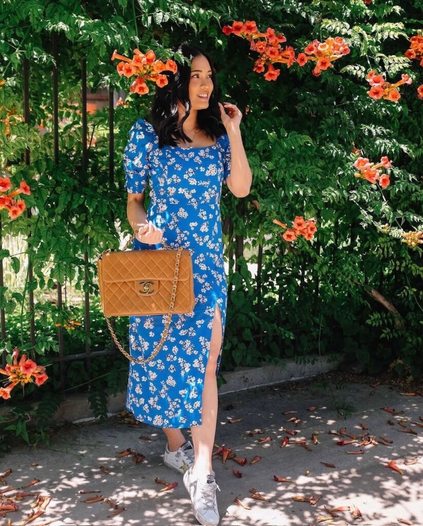 woman in blue floral dress with sneakers