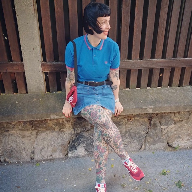 woman in blue top and denim mini