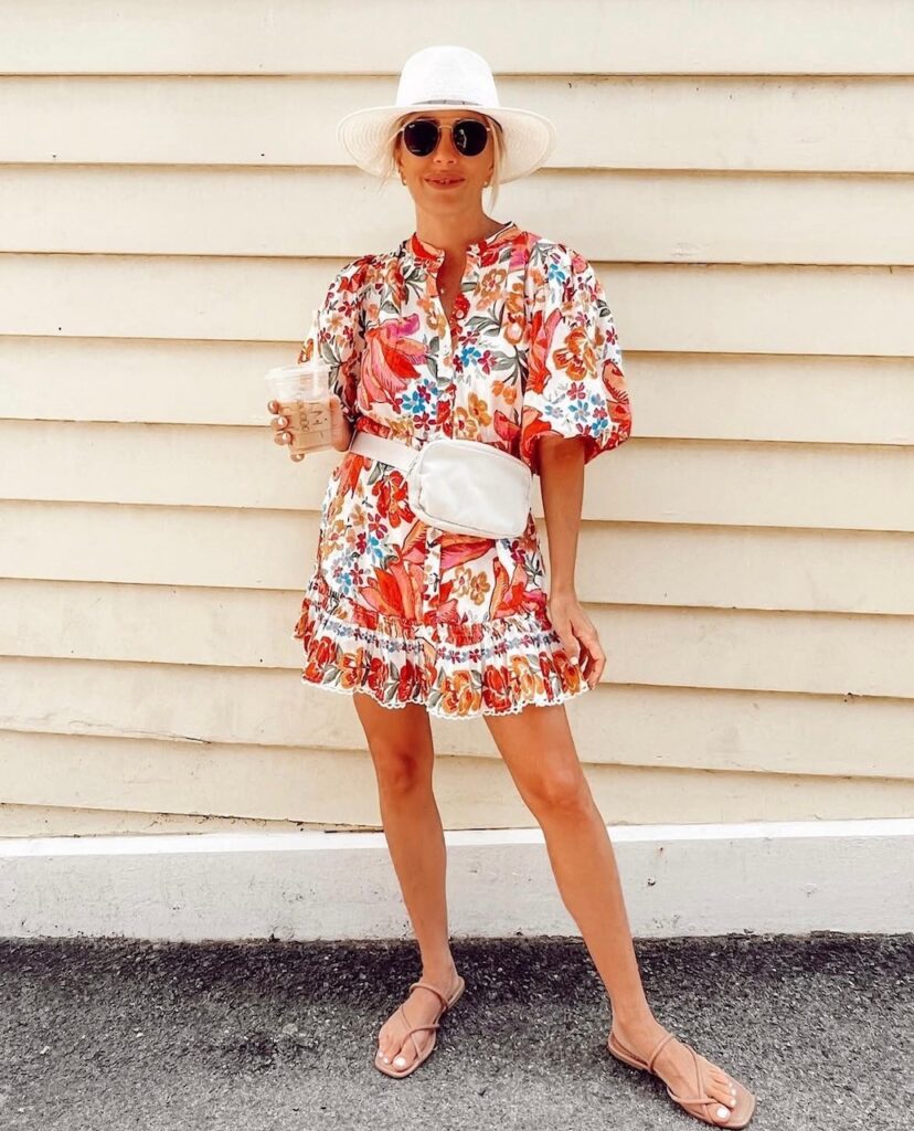 woman in floral dress with white belt bag