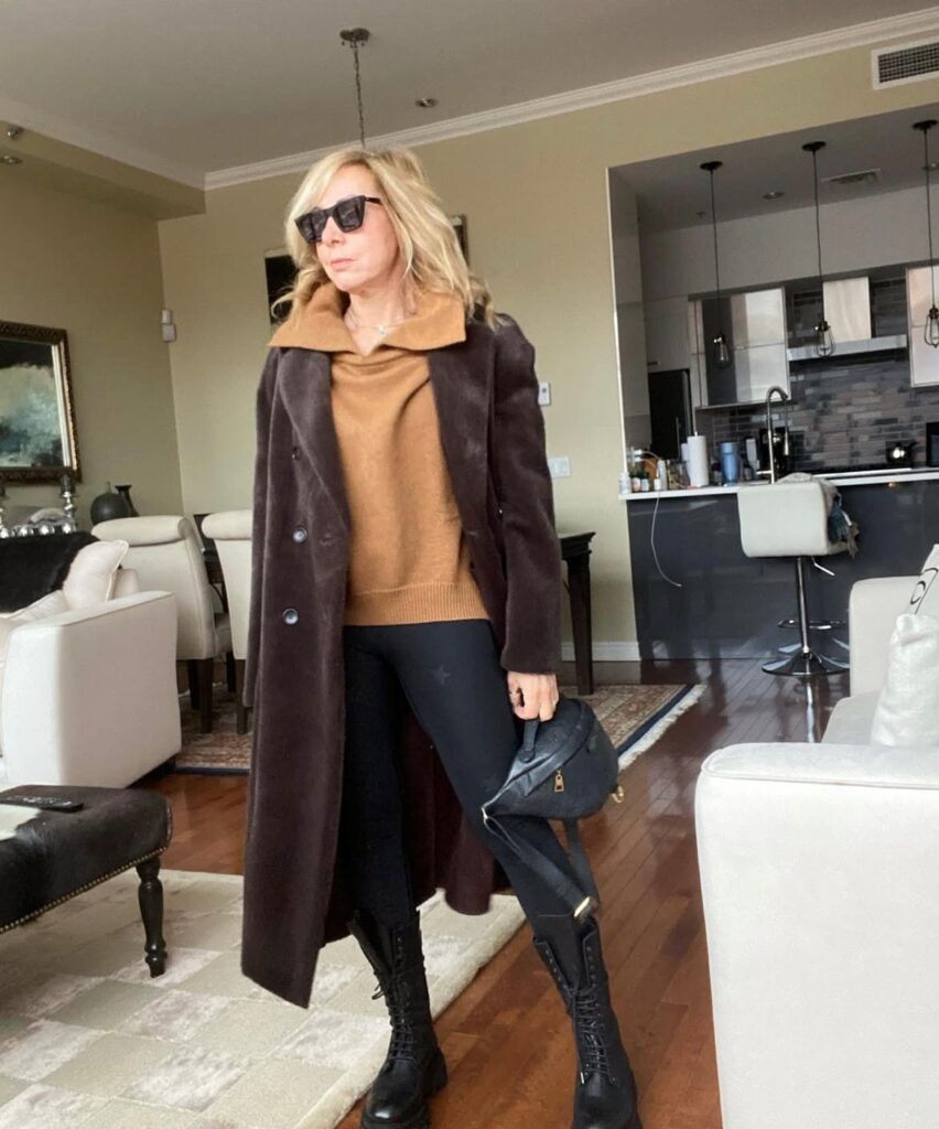 woman in polo sweater with leggings and long brown coat