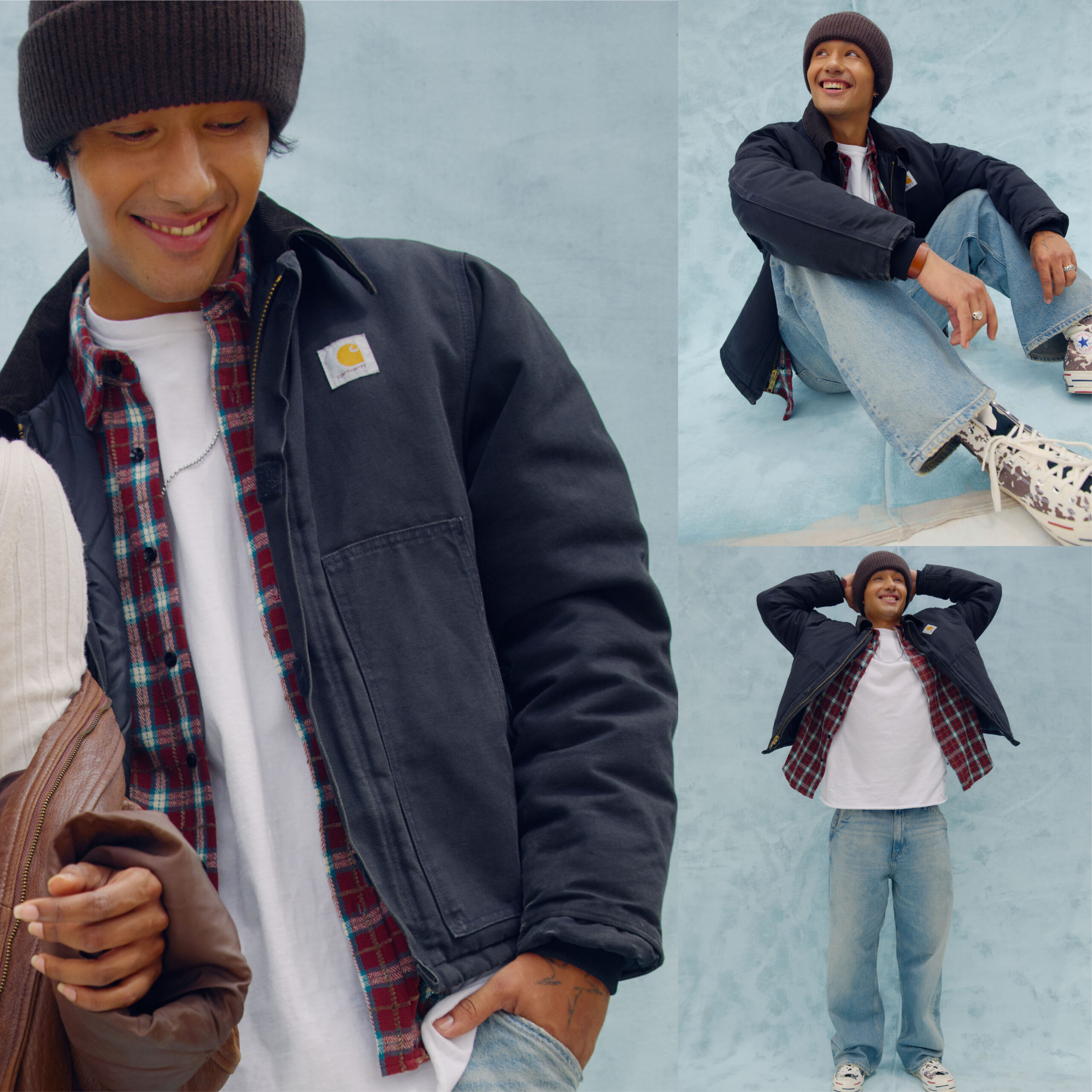 Male model is wearing a black carhartt zip up jacket over a red flannel and white tee, blue baggy jeans and printed high top converse