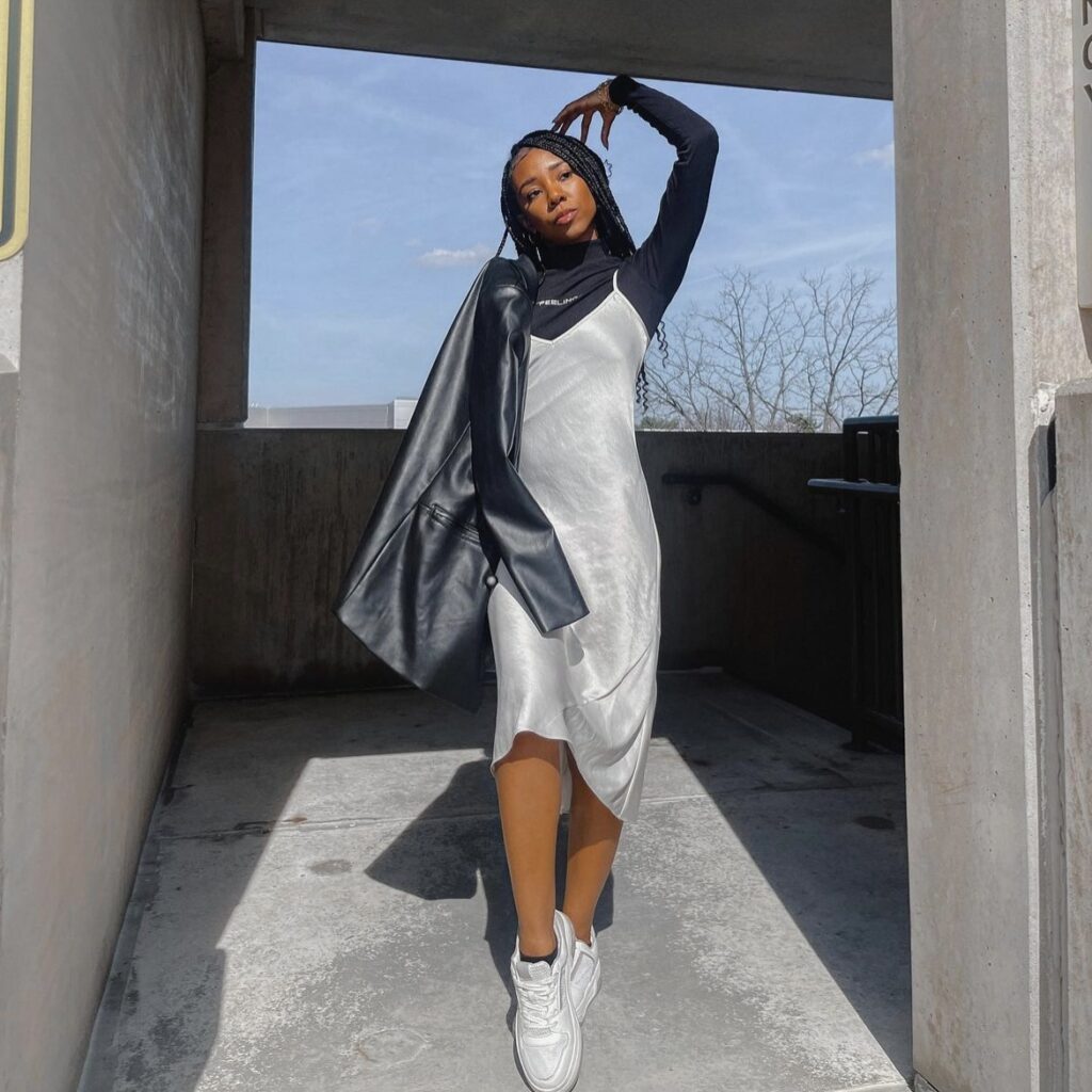 woman in silver slip dress over black turtleneck