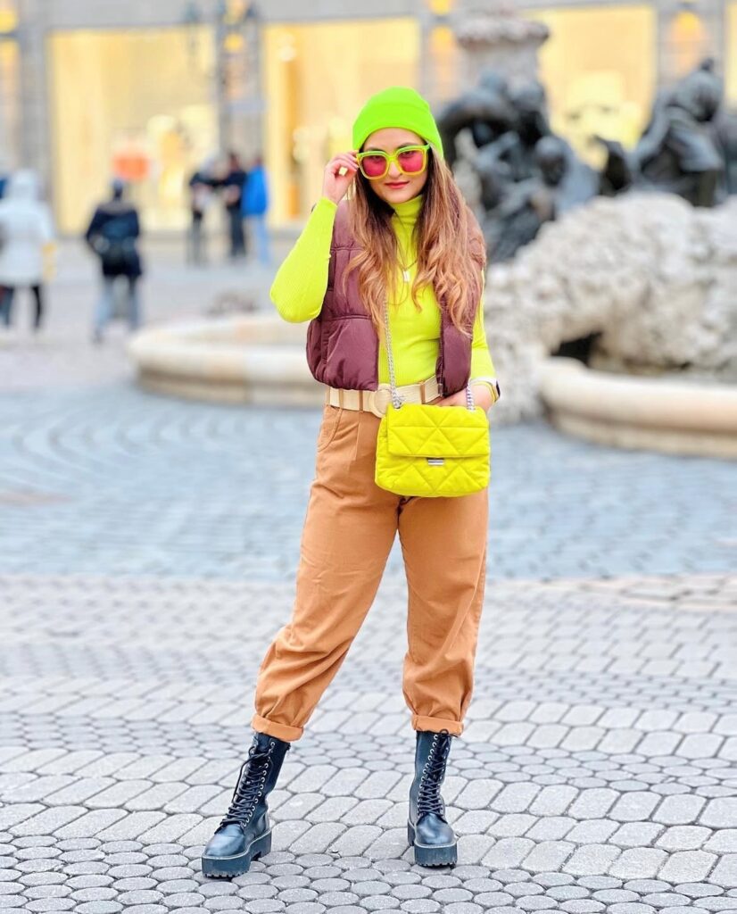 woman wearing a neon yellow sweater and lime green beanie