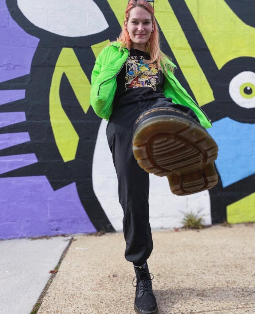 person in neon green puffer jacket with black t-shirt and jeans