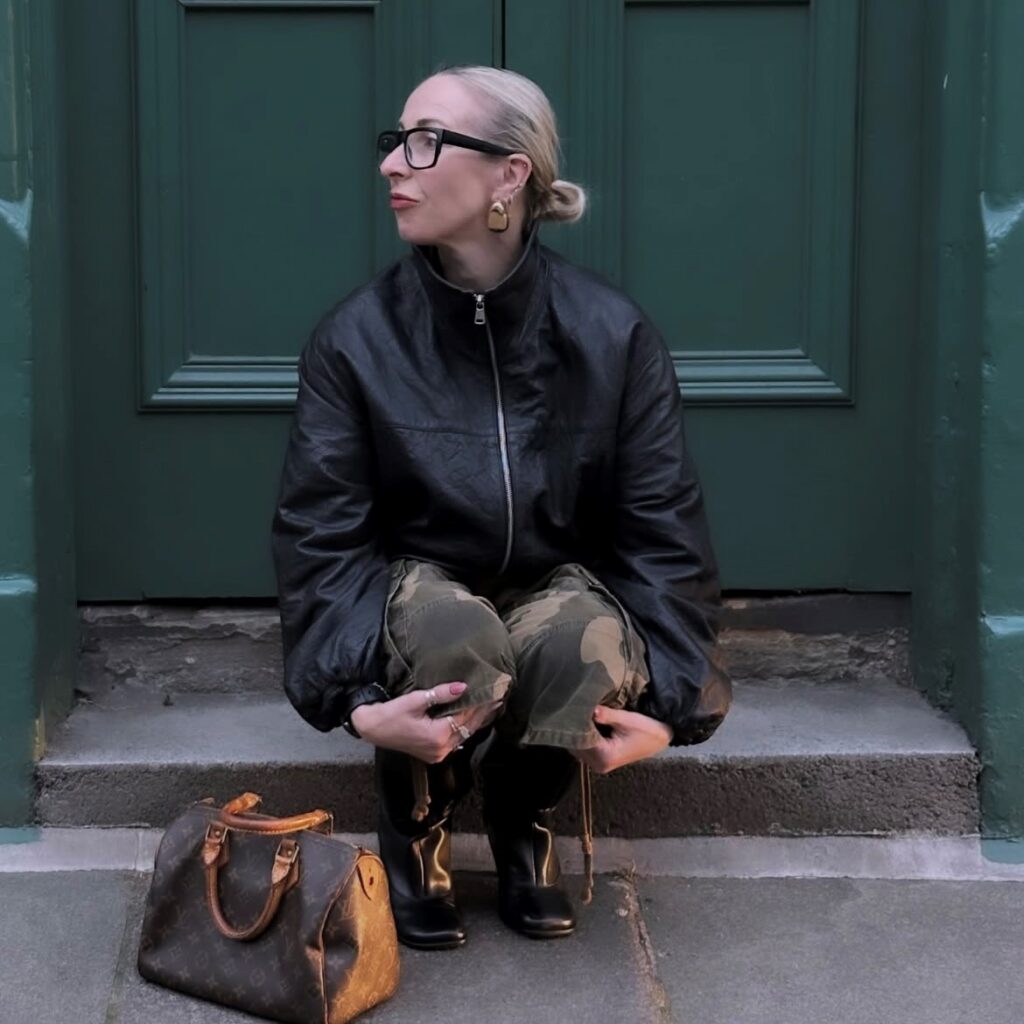 woman in black leather funnel neck jacket