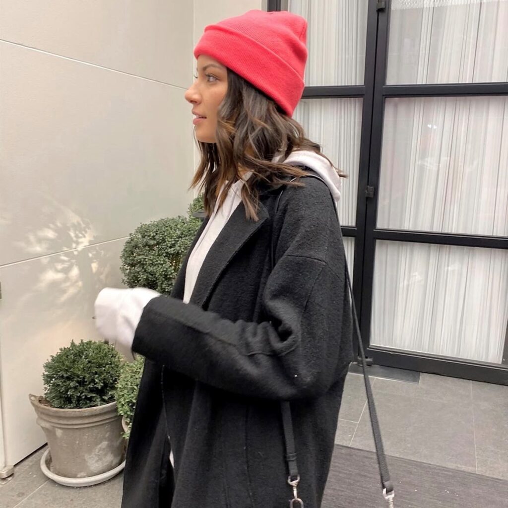 woman in brightly colored pink beanie