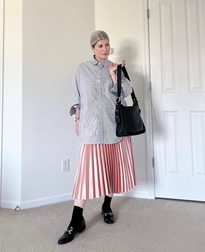 woman dressed in a modern preppy look with pink maxi skirt and oversized button-up
