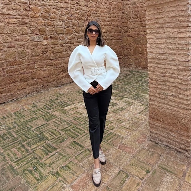 woman in black leggings and ivory colored balloon-sleeved jacket