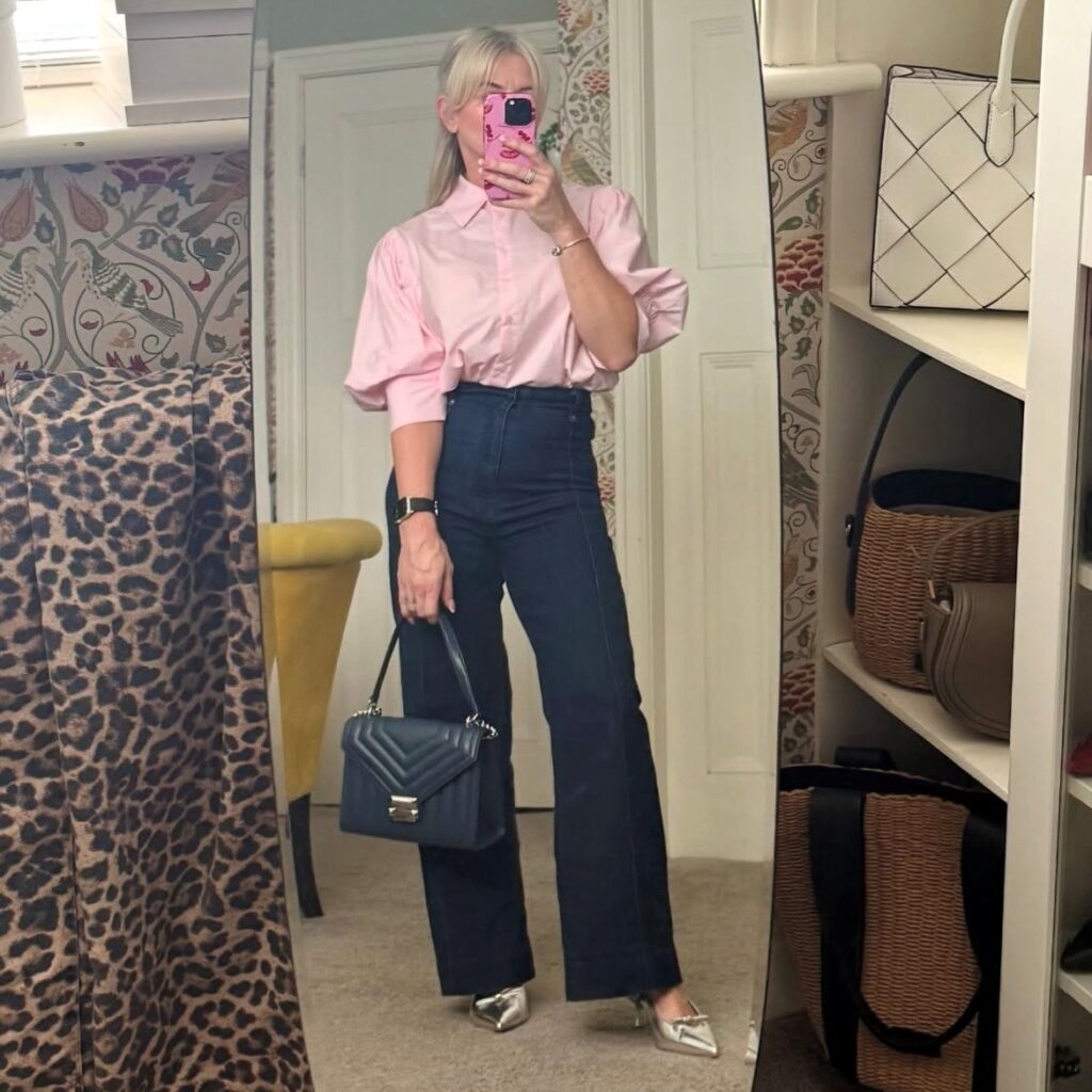 woman wearing jeans with a pink top with balloon sleeves