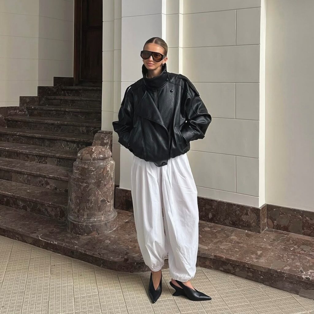 woman in balloon pants and cropped leather jacket
