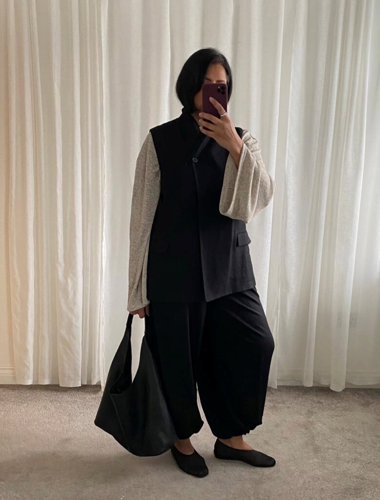 woman in black balloon pants and knit top