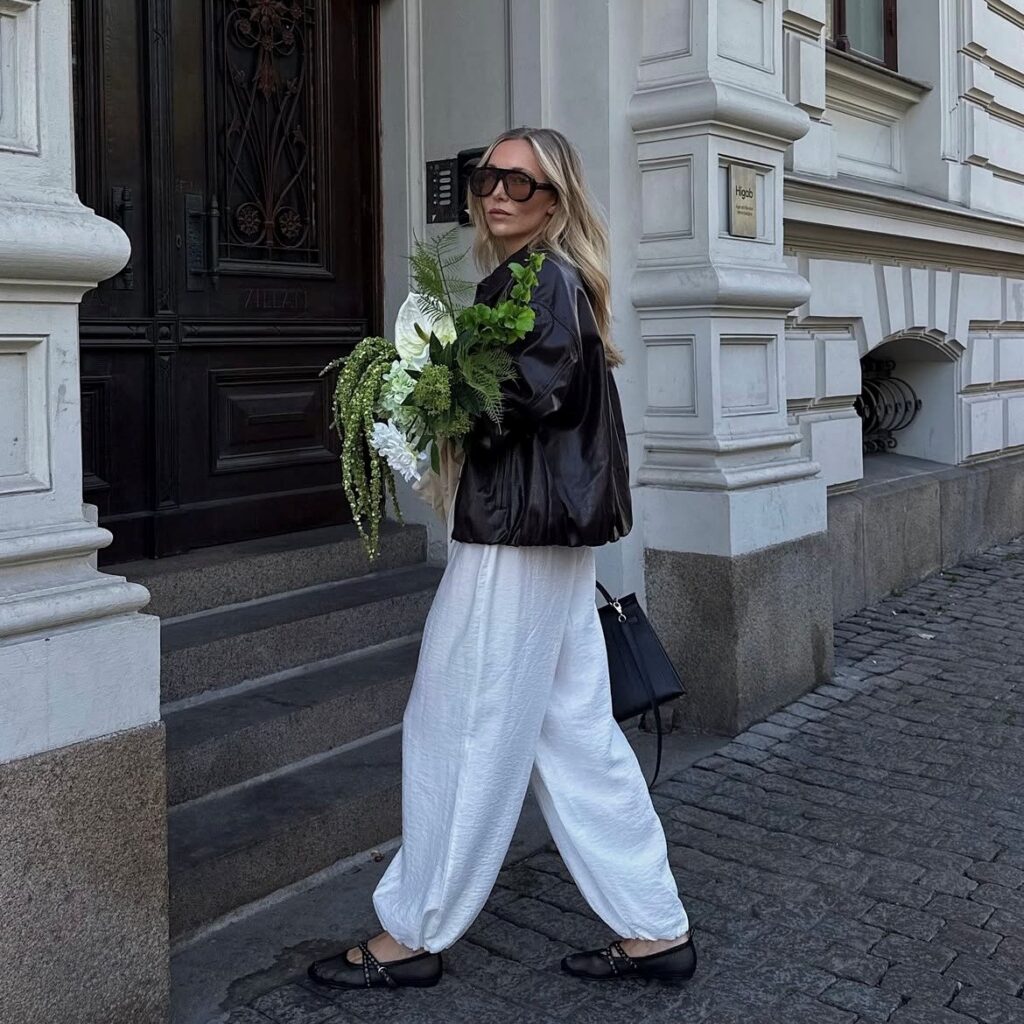 woman in balloon pants and leather jacket