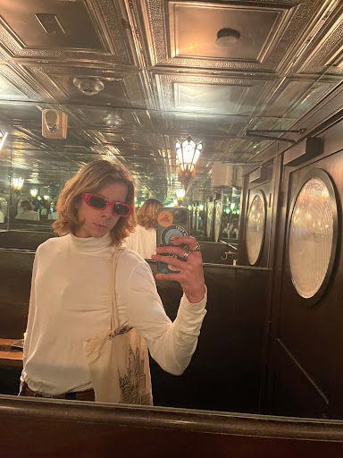 Nolan taking a selfie in red framed glasses