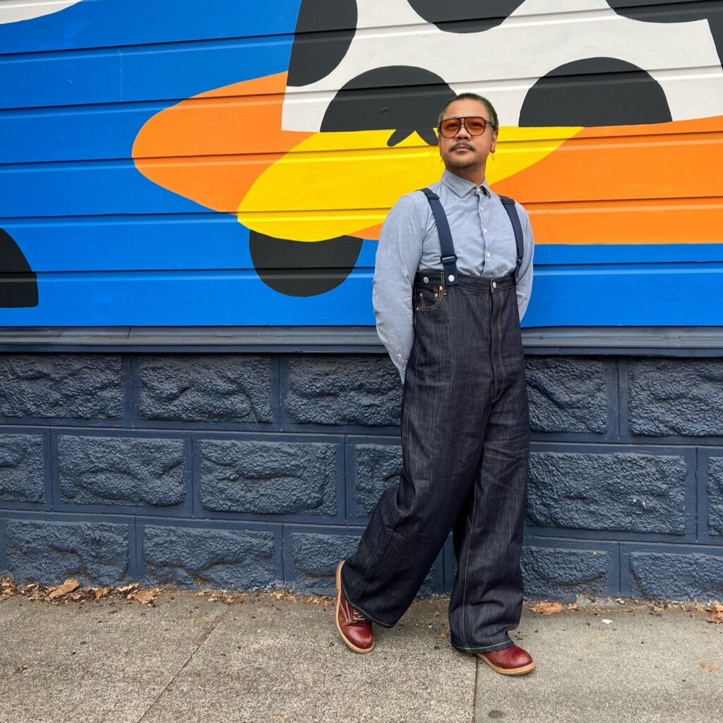 Arnel in front of a Crossroads storefront