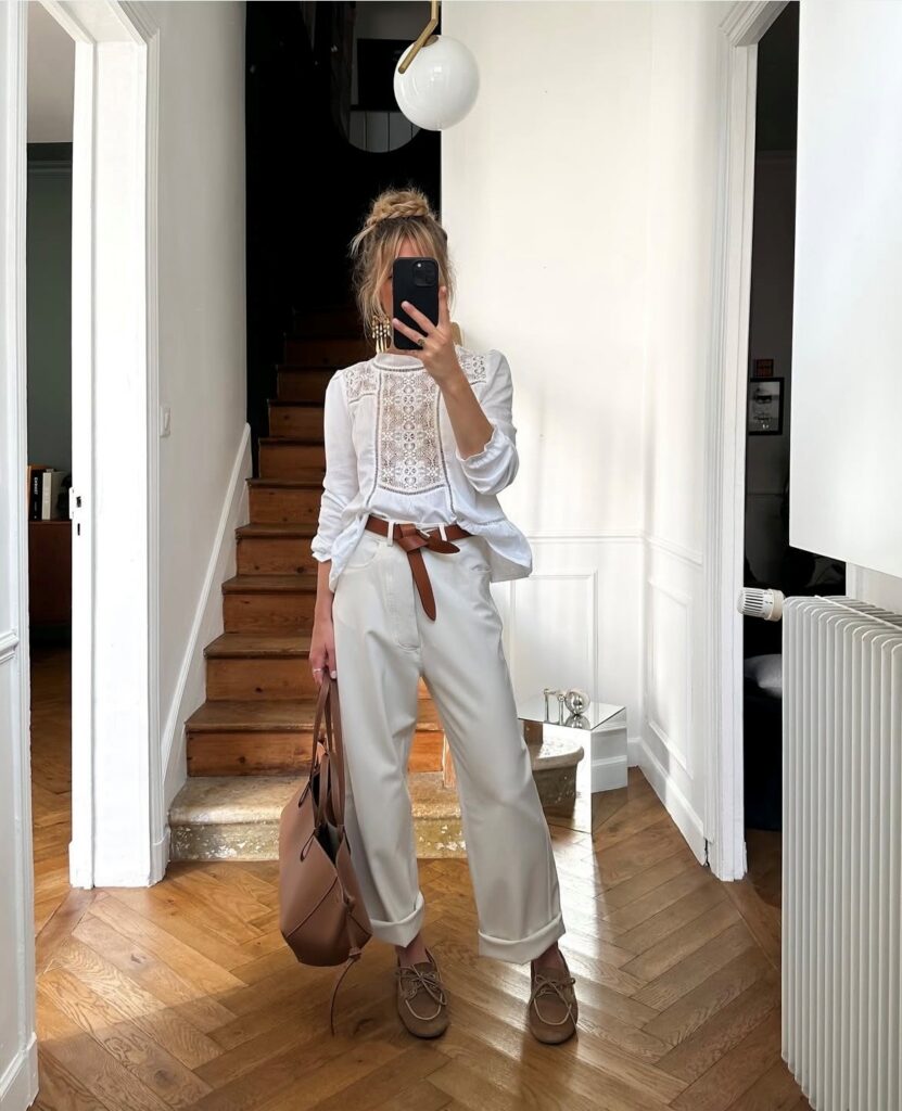 woman in peasant blouse and belted trousers