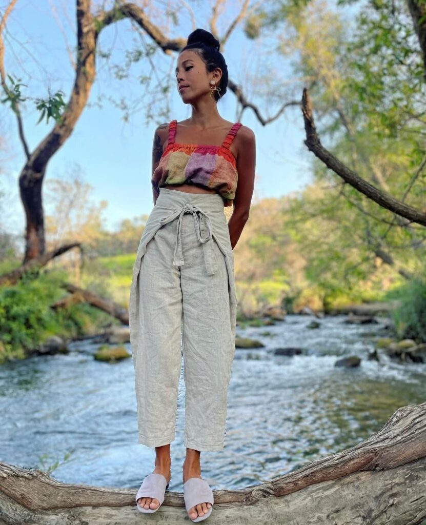 woman in rainbow tank top and cropped linen pants