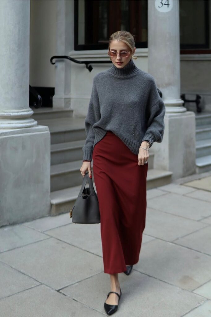 woman in burgundy slip dress with gray oversized sweater