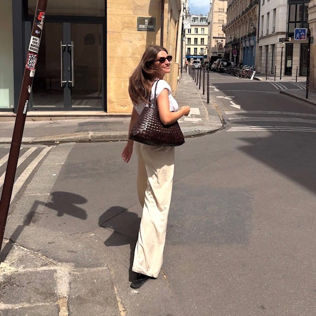 Woman carrying a brown woven bag