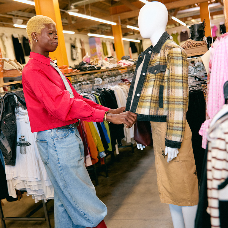 employee dressing a mannequin