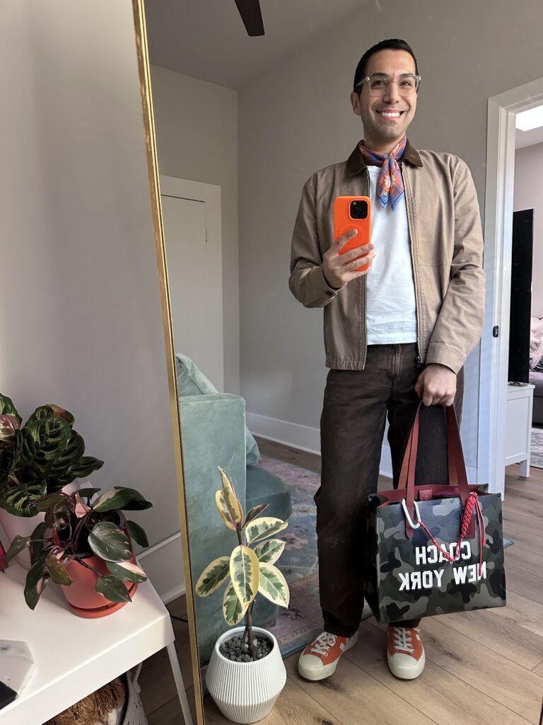 Jason wearing a white tee with brown jacket and pants.
