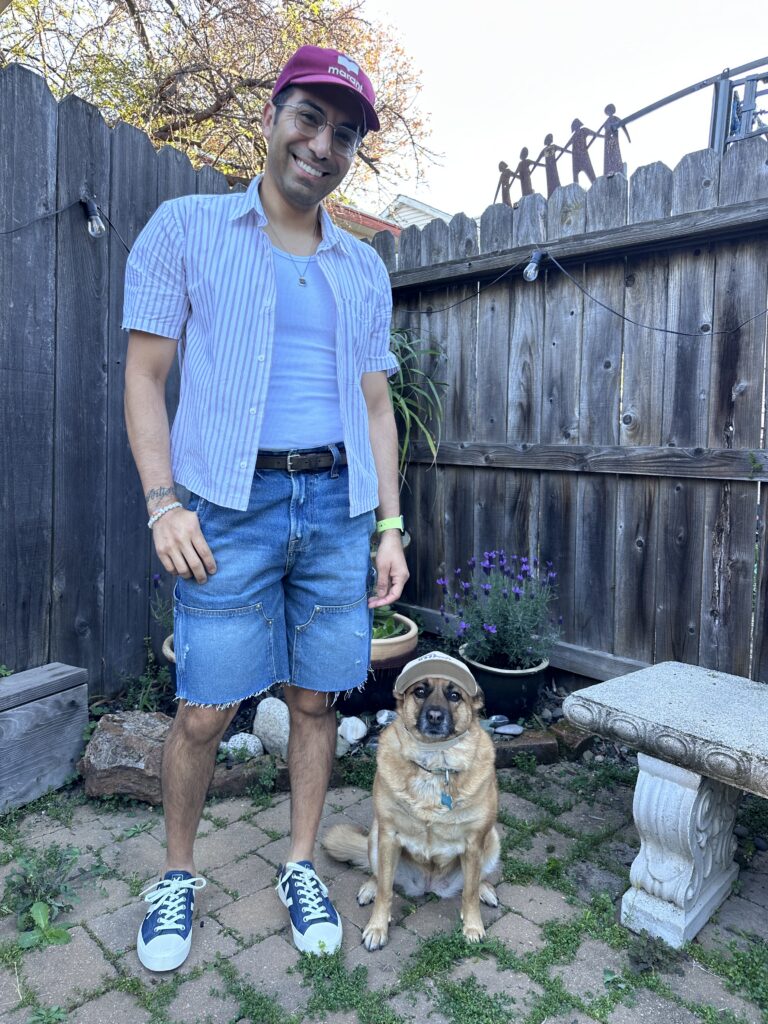 Jason wearing jean shorts, tank, and short-sleeve striped button-up