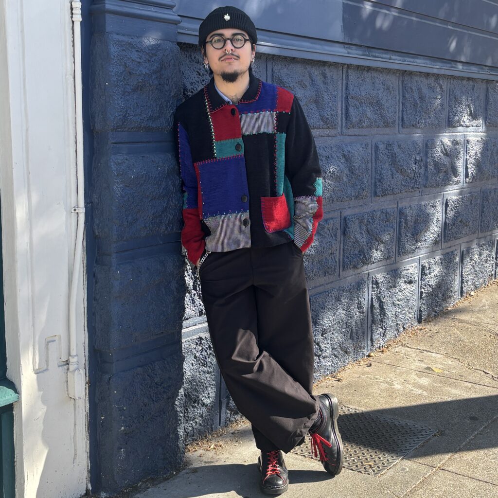 Noah in patchwork cardigan and trousers