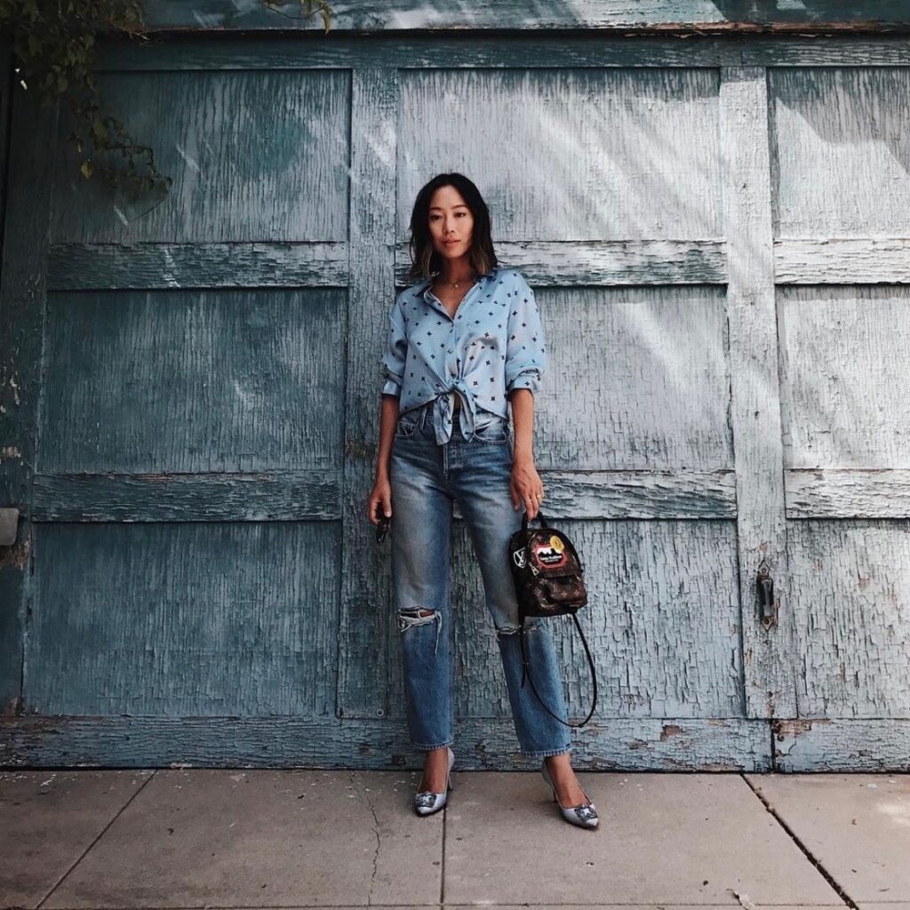 woman in pajama top and distressed jeans