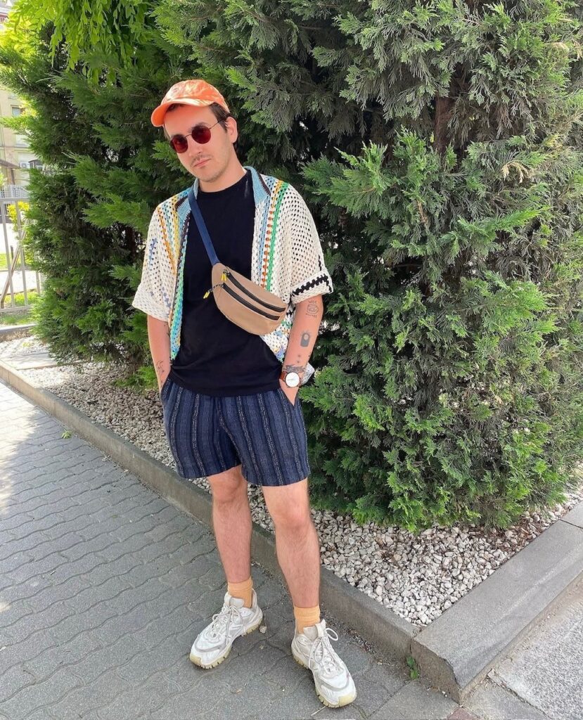 Man in shorts, t-shirt, and crochet top