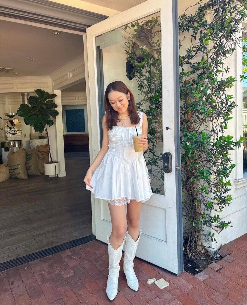 woman in little shite dress with white cowboy boots