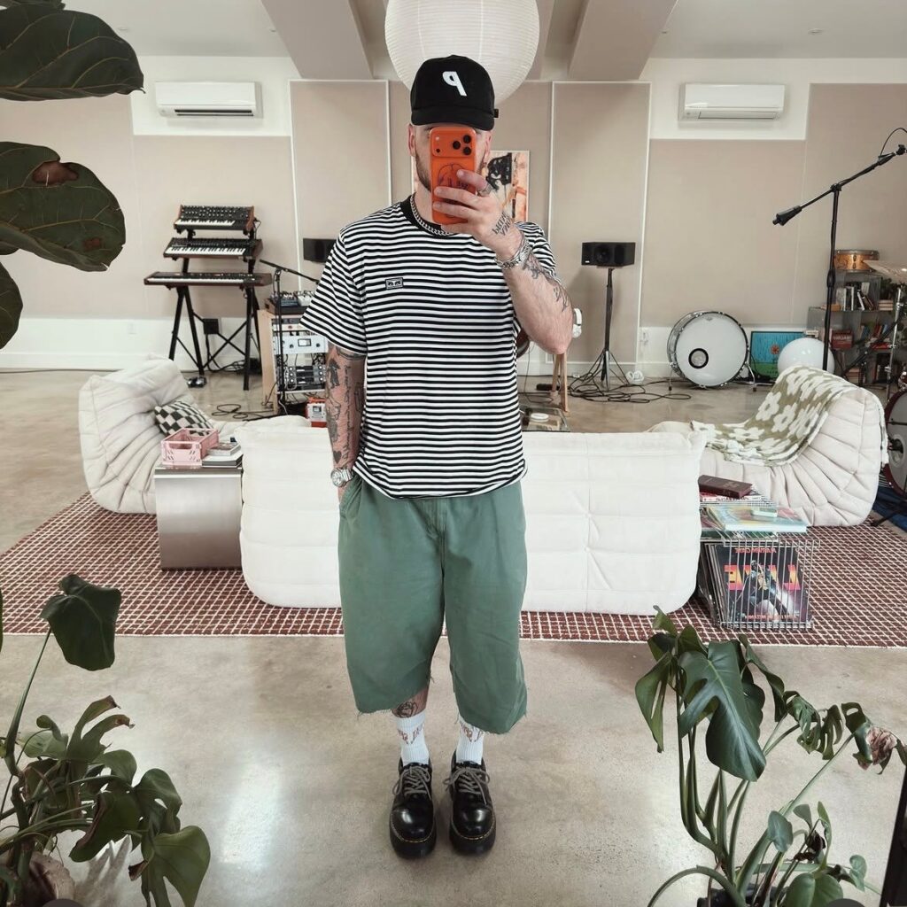 Man in long shorts with striped tee