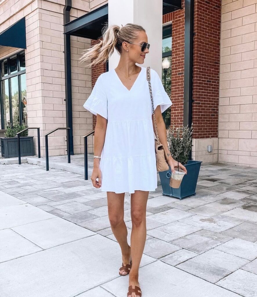 woman in v-neck white dress with sandals