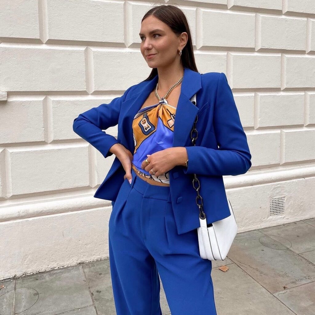 woman in royal blue suit with scarf top