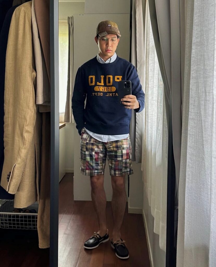 man in Bermuda shorts and sweatshirt