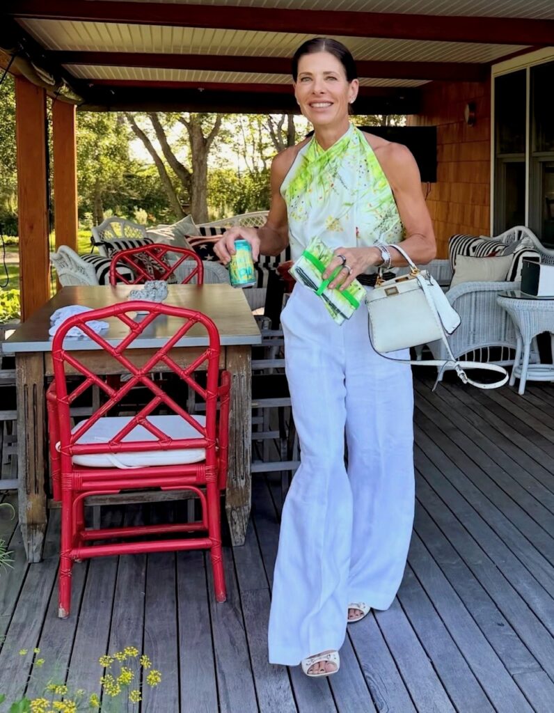 woman in lime print top and white linen pants