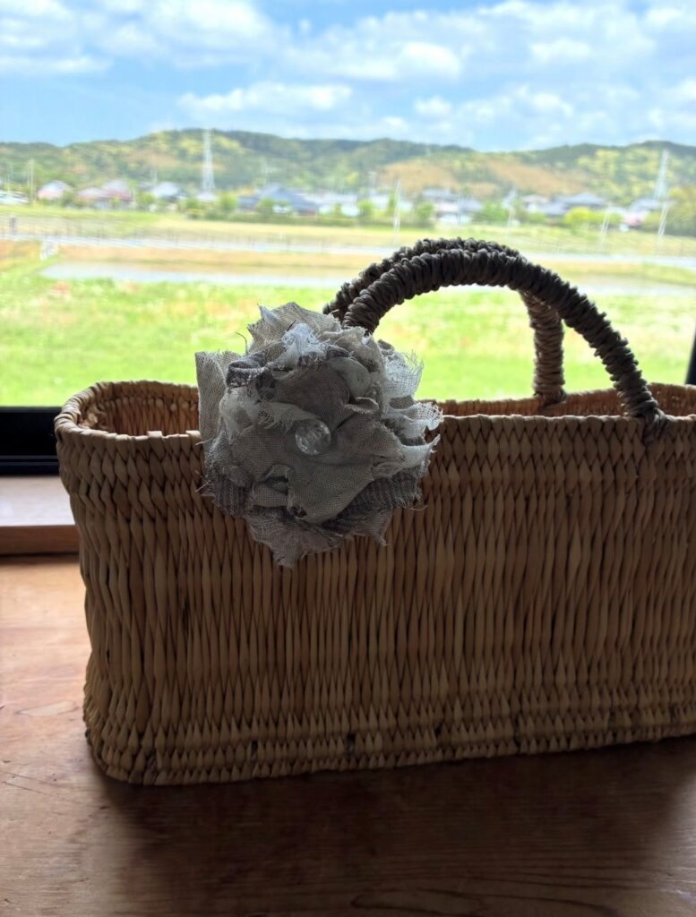 floral brooch on straw tote bag