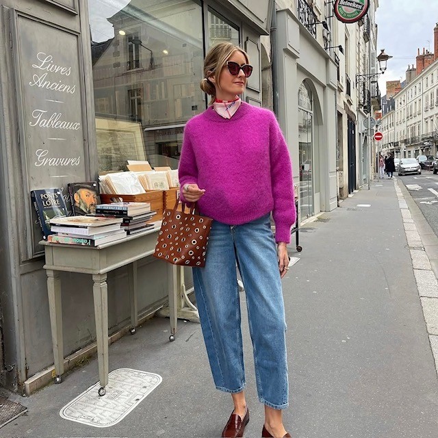 woman in fuchsia sweater with cropped jeans and loafers