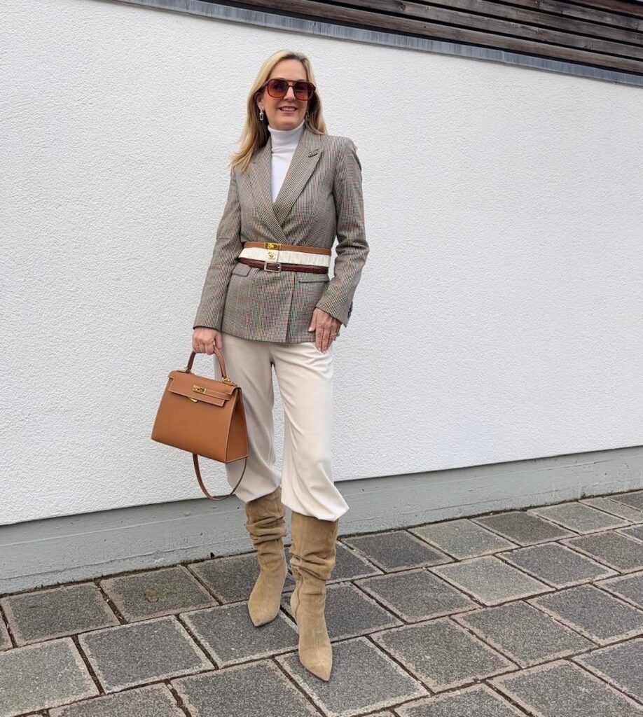 woman in blazer, cream colored pants, and slouchy boots
