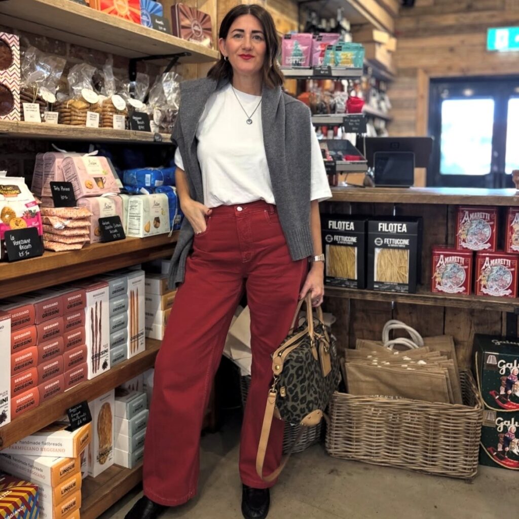 woman in red denim pants with white tee