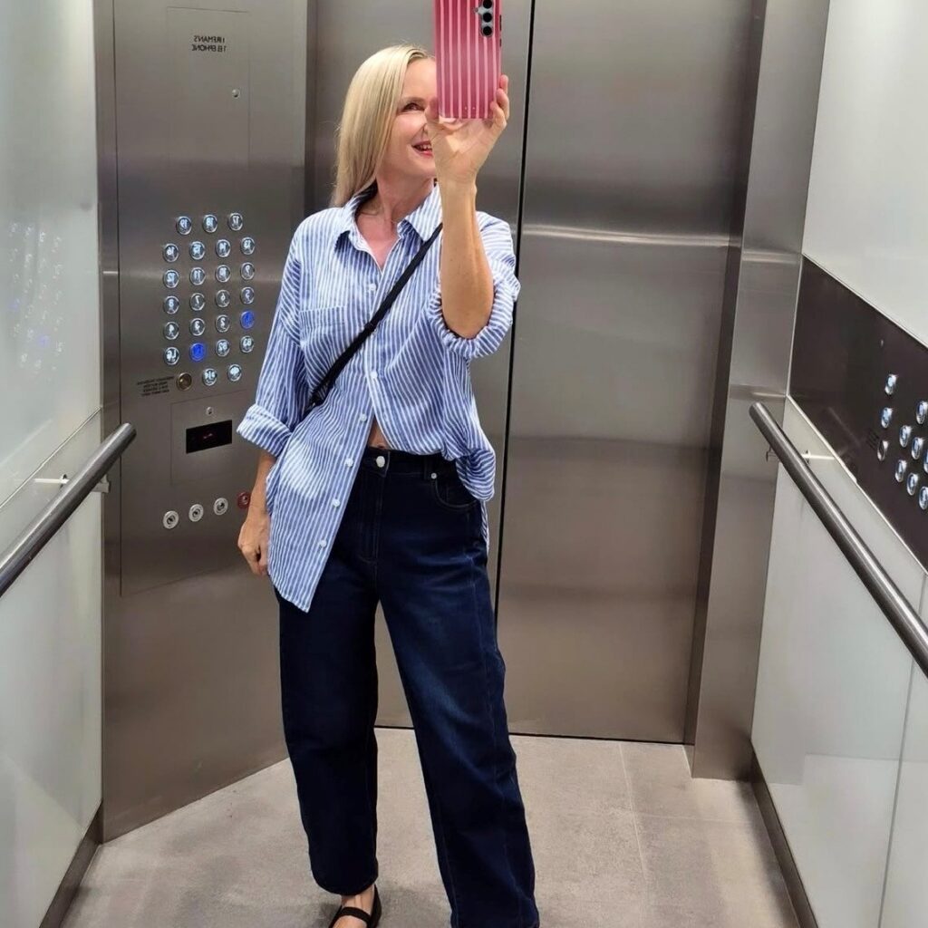 woman in oversized button down and straight leg jeans