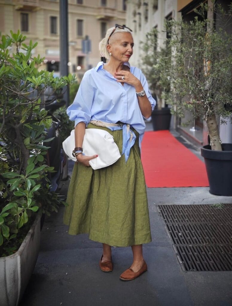 woman in large boyfriend shirt and olive green linen midi skirt