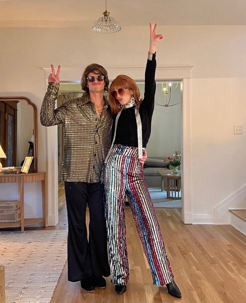 couple wearing disco costumes